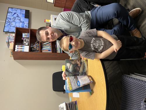 Mr. Haglund and a student enjoying a book!